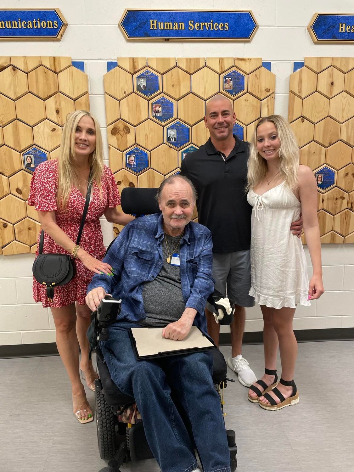 Michael Becker with his daughter Cheylene Varto, son-in-law Robert Varto and granddaughter Kira Varto in front of the Wall of Fame at HHS.